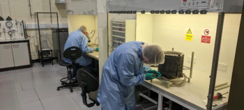 Technicians working on satellite parts