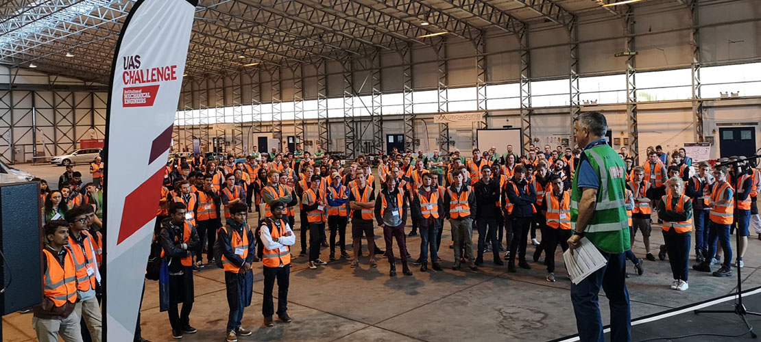 IMechE UAS Challenge 2018 Teams wearing hi-vis in hangar at start of competition
