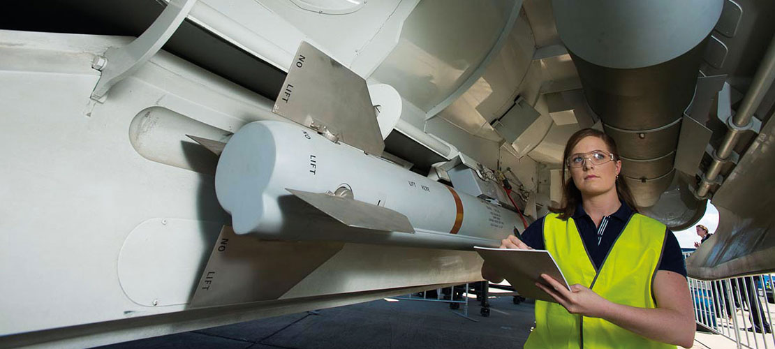 Aircraft Structural Integrity showing engineer checking aircraft on ground near missile