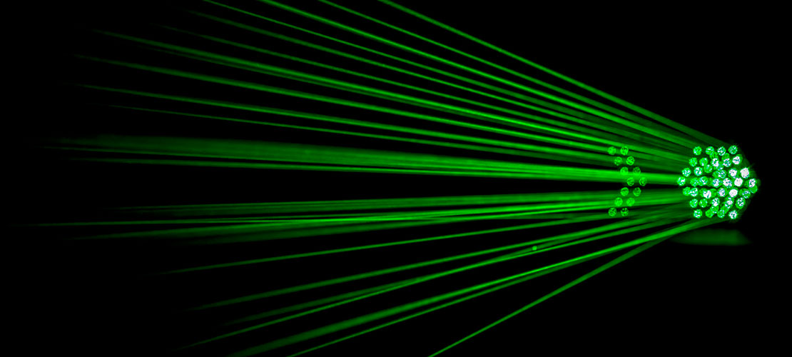 Laser Dragonfire green against black background
