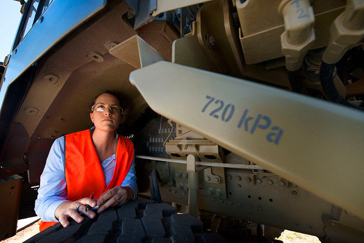 Woman inspecting car